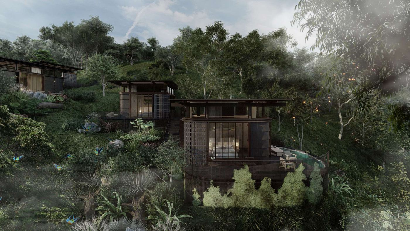 Villas de Awita escalonadas sobre una ladera boscosa entre niebla.