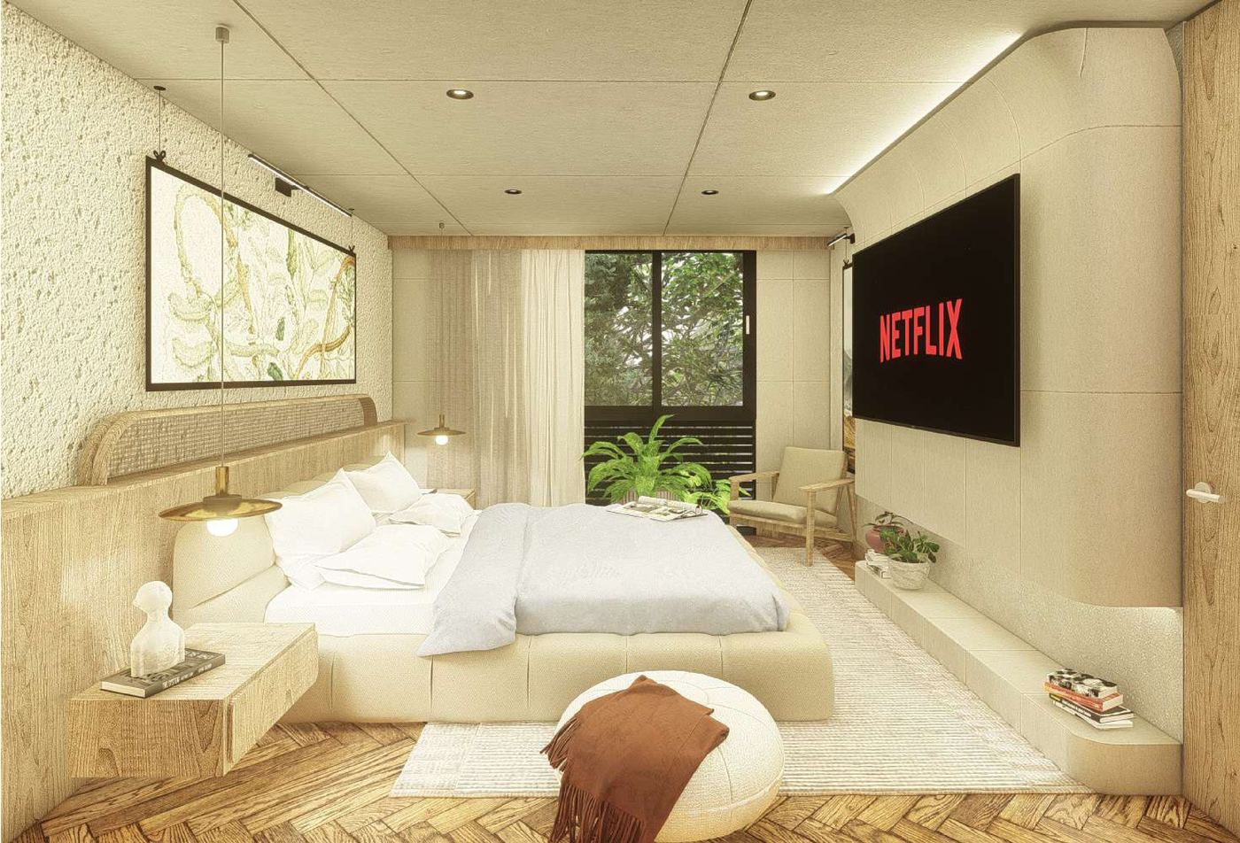 Habitación del penthouse con piso de espiga, cabecero tapizado y ventanal hacia la vegetación.